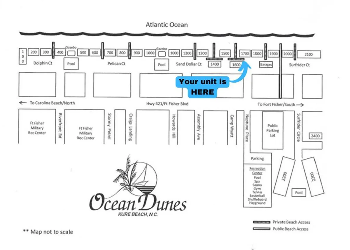 This image offers a bird's-eye view of the property, prominently showcasing the assigned parking areas, the proximity to the Atlantic Ocean, and the recreation center. The parking lots, building entrance, and pathways are all visible, providing clear context for arrival and access.